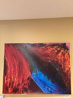Full view of framed abstract canvas showing red and blue composition
