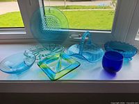 All seven glass pieces displayed on windowsill