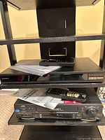 Sony Blu-ray player on shelf with remote and manuals visible