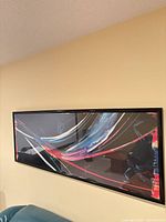 Full view of framed abstract print on wall