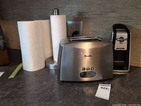 Breville toaster, Hamilton Beach electric can opener, stainless paper towel holder, two paper towel rolls
