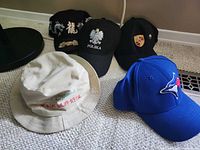 Five assorted caps laid out on carpet