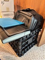 Overall view of both laptop cases, two portfolios and Staples file crate