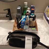 Overview of grooming products on countertop with toiletry bag
