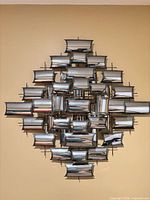 Full view of welded metal wall sculpture mounted on wall