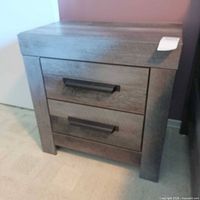 Front view of grey two-drawer Ashley Wynnlow nightstand showing bar pulls
