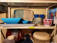 Full lot on shelf showing trays, chip bowls, Pfaltzgraff bowls and striped bowl