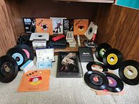 Overview of lot showing microphones, vinyl records, cassettes, cleaners, DVD set