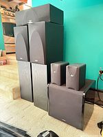 All speakers grouped: two floorstanding, centre channel, two satellites on subwoofer, Paradigm subwoofer