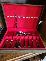 Open canteen showing full set of flatware pieces in red felt interior