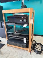 Front view of wood stereo stand with four shelves