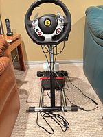 Full setup showing wheel, base, pedals and stand