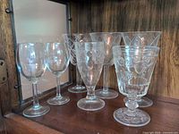 Seven pieces of clear stemware on shelf