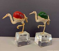 Front view of both crane figurines showing gemstones, rhinestones, bases