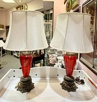 Front view of both ruby red glass lamps with shades
