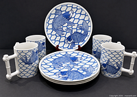 Full set of four mugs and four plates showing pattern and handles