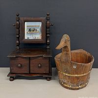 Full view of both items: duck bucket and small dresser mirror