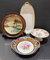 Group shot of four porcelain pieces showing forms and decoration