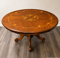 Top view showing round shape, marquetry design, glass