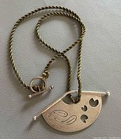 Full view of pendant on cord showing overall design