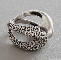 Ring three-quarter view showing polished and textured sections, hallmark visible