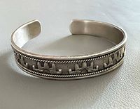 Full view of cuff showing rope edges and elephant motif
