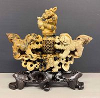 front view showing Fu dogs, honeycomb carving, lid and stand