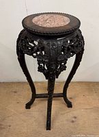 Full view of plant stand showing carved legs, apron and marble top