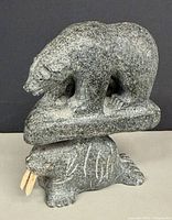Front view of soapstone bear on walrus sculpture