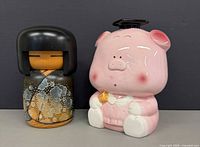 Front view of Kokeshi doll and piggy bank