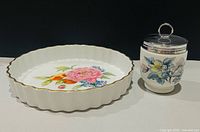 Dish and egg coddler side by side showing scale and patterns