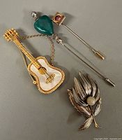 Group shot of four pins and brooches