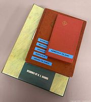 Green H.E. Harris slipcase and brown stockbook album