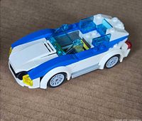 Angled side-front view of assembled Lego police car showing color scheme and details