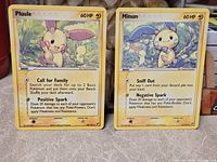 Front view of Plusle and Minun cards together showing artwork, HP, attacks and numbering