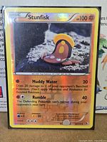 Front of sleeved Stunfisk reverse holo card showing HP 100 and attacks
