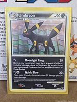 Front of Umbreon cracked-ice holo card showing artwork, moves and 10/90 numbering