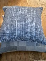 Two square pillows stacked showing front patterns