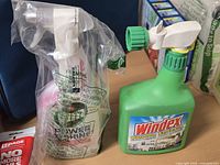 Windex hose-end sprayer bottle and Vim spray cleaner in plastic bag