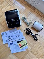 Printer, cables, spare roll, manuals displayed