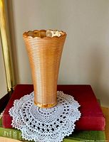 Full view of vase standing upright showing color, ribbing and scalloped rim