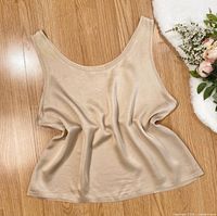 Front view of beige silk camisole laid flat
