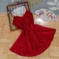 Full view of red paisley satin slip dress laid flat