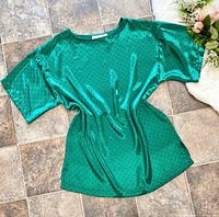 Front view of emerald green satin sleep shirt laid flat