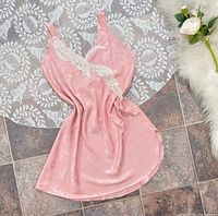 Full view of front of pink satin slip dress on tile backdrop