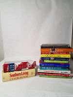 Photo showing 14 cookbooks stacked with visible titles including Southern Living Cookbook and Bobby Deen Cooking Book.