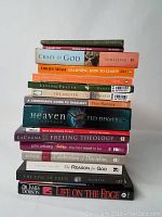 Stack of 16 books on religious and spiritual topics, titles and authors visible on spine