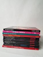 Photo of a stack of eleven craft, sewing, and home improvement books showing titles and condition.