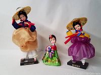Three Korean native dolls arranged with visible clothing and poses to show detail and size difference