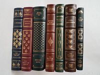 Front spine view of 7 limited edition Franklin Library books showing titles and authors with gold embossed details.